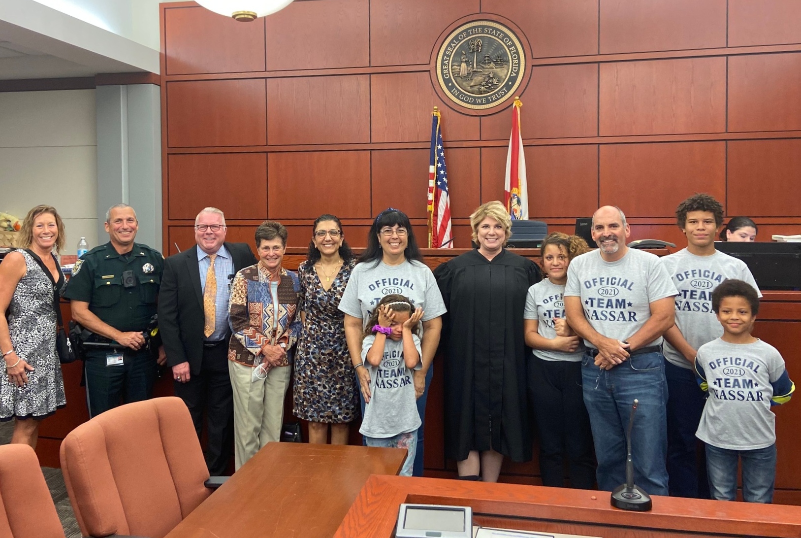 Judge Mary Evans with a family and members of the Charlotte Sheriff’s Office, DCF, Children’s Network, and Lutheran Services Florida. 